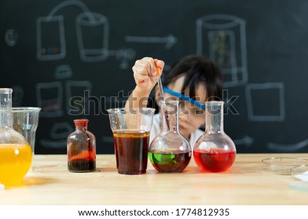 Adorable asian little girl is make easy scientific experimental at home, concept of learn from home, child STEM education and science for kid. Royalty-Free Stock Photo #1774812935