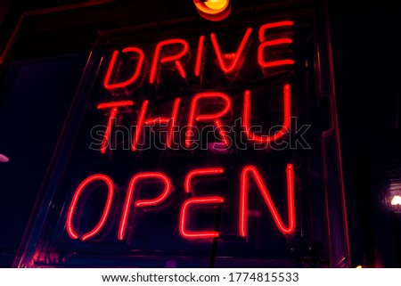 red neon sign lettering DRIVE THRU OPEN Royalty-Free Stock Photo #1774815533