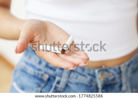 Stop smoking, close up of woman breaking cigarette