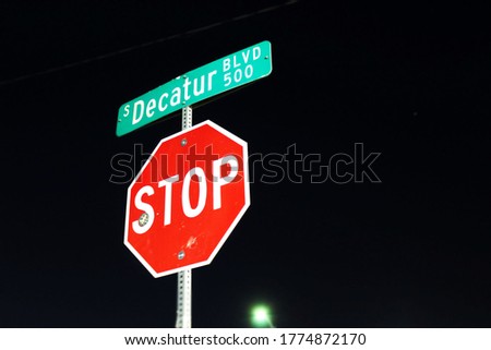 Stop Sign and Street Sign at Night
