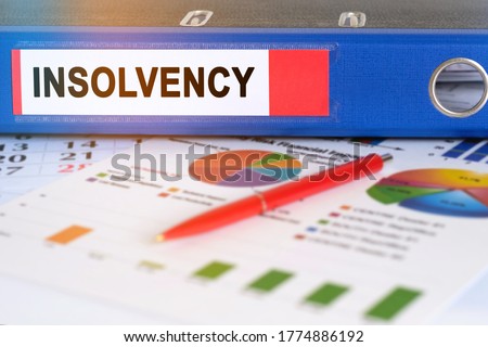 On the table are pie charts, a pen and a folder with the inscription - INSOLVENCY. Business and finance concept. Royalty-Free Stock Photo #1774886192