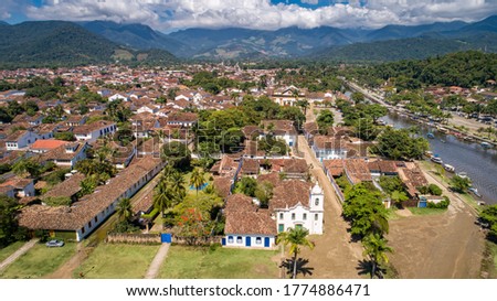 Aerial view to historic town Paraty with tidal river and green mountains in background on a sunny day, Brazil, Unesco World Heritage