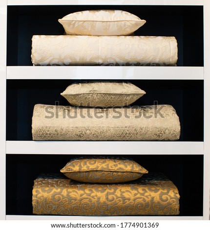 pillows and bedspreads on shelves