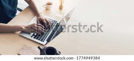 using computer.hand typing keyboard laptop online chatting search form internet while working sitting at coffee shop.concept for.technology device contact communication business people Royalty-Free Stock Photo #1774949384