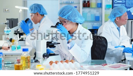 Asian Quality control expert inspecting at food specimen meat in the laboratory