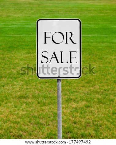 for sale sign on the green lawn