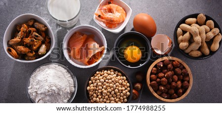 Composition with common food allergens including egg, milk, soya, peanuts, hazelnuts, fish, seafood and wheat flour Royalty-Free Stock Photo #1774988255
