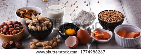 Composition with common food allergens including egg, milk, soya, peanuts, hazelnuts, fish, seafood and wheat flour Royalty-Free Stock Photo #1774988267
