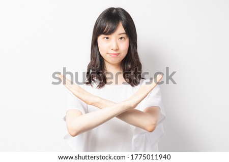 Young woman making an NG gesture