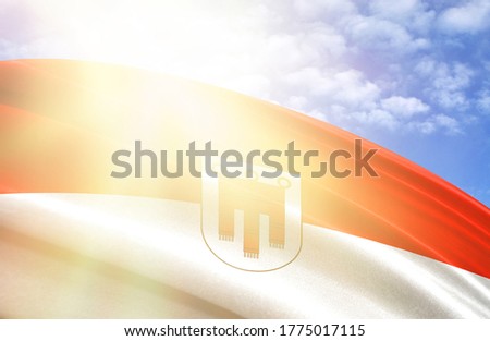 flag of Vorarlberg against the blue sky with sun rays