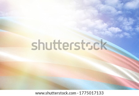 flag of Transgender against the blue sky with sun rays