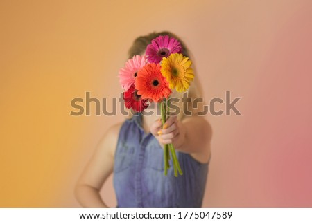 Beautiful romantic woman  holding chamomile bouquet. Cheerful young lady  and flowers chamomile in hands.
