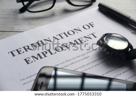 Selective focus of watch,mobile phone,pen,glasses and Termination of Employment letter on a white wooden background. Royalty-Free Stock Photo #1775053310