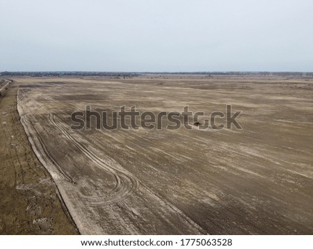 Agricultural fields on a cloudy evening, aerial view. Landscape.