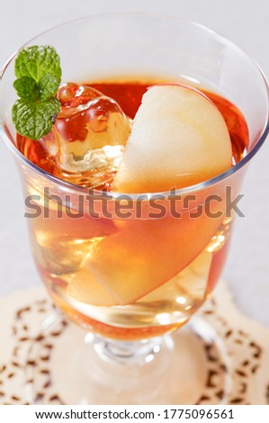 Glasses of cold ice tea with apple, ice, mint on background. Spring and summer drinks and beverages concept.
