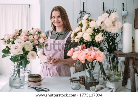 Portrait of a young attractive florist girl in flower shop