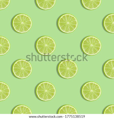 Colorful fruit seamless pattern of fresh lime slices on green background. Trendy sunlight Summer pattern. Minimal summer concept. flat lay food texture