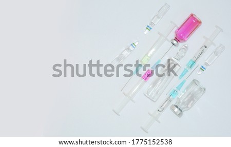 Medical banner background with vaccine, ampoules, 
syringes and tablets. Coronavirus Covid-19 pandemic concept