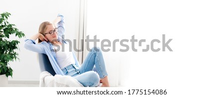 Young woman relaxing under air conditioner at home. Girl resting on couch, enjoying cool fresh air in cozy living room. White background, copy space. Self isolation, social distance in quarantine.