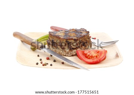 extra thick hot beef meat hamburger lunch on light wooden plate with tomatoes salad and cutlery isolated on white background