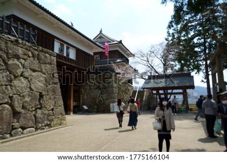 Blurred image of people sightseeing in Japanese castle
