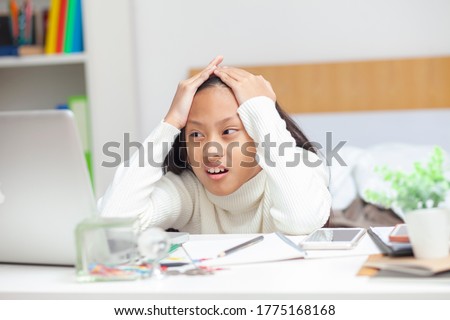 Stressed student woman memorizing on laptop studying sitting on a desk at home.Work from home,Stay at home. Royalty-Free Stock Photo #1775168168