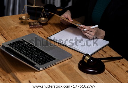Law and Legal services concept, Good service cooperation, lawyer hands working on wood table office, Law interface icons, Soft focus.