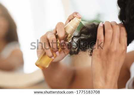 Split Ends Remedy. Unrecognizable Black Woman Applying Moisturising Spray To Her Curly Hair At Home, Closeup Royalty-Free Stock Photo #1775183708