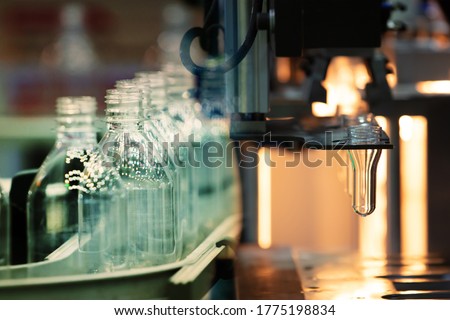 PET Preform in PET bottles blow molding machine in factory. Technology in plastic bottles machine for industry. Industrial and factory concept. Royalty-Free Stock Photo #1775198834