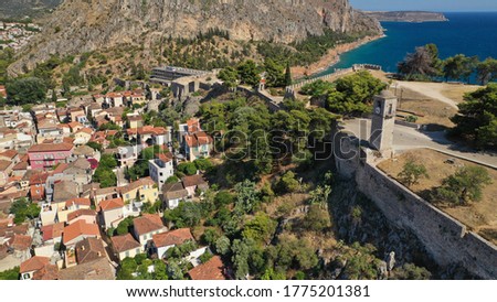 Aerial drone photo of medieval old clocl tower in Acronafplia castle overlooking historic and picturesque seaside old town of Nafplio, Argolida, Peloponnese, Greece