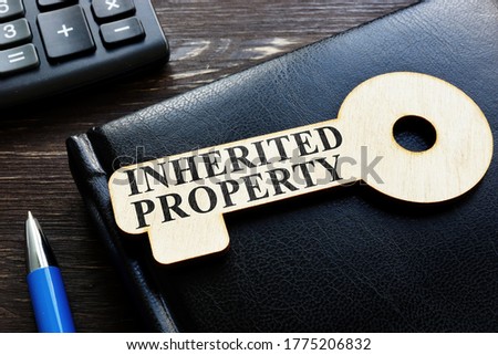 Inherited property phrase on the wooden key. Royalty-Free Stock Photo #1775206832