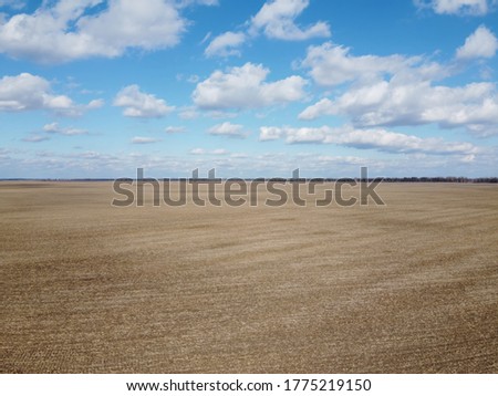Beautiful blue sky over farm fields on a sunny day, aerial view. Landscape.