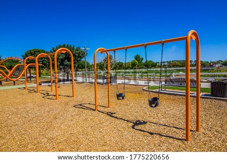Bright Orange Swing Sets At Public Park Royalty-Free Stock Photo #1775220656