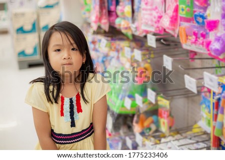 Asian girls shop for toys at department stores.