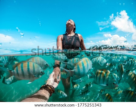 Young couple swimming in the natural pools in Porto de Galinhas Pernambuco - Brazil Royalty-Free Stock Photo #1775251343