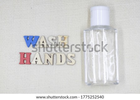 Wash hands word in block letters and hand sanitizer bottle.