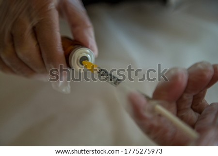 Doctor with Vial and medical syringe