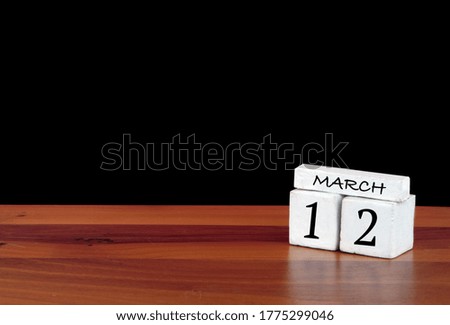 12 March calendar month. 12 days of the month. Reflected calendar on wooden floor with black background
