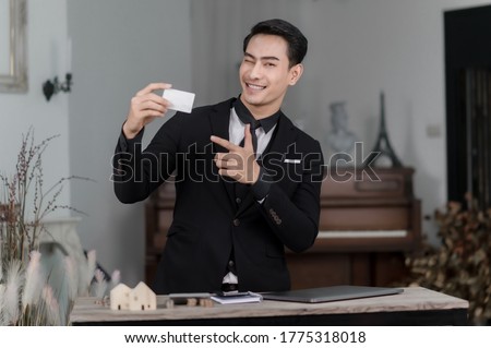 Man holding blank white credit card mockup front side view. Plastic bank-card design mock up