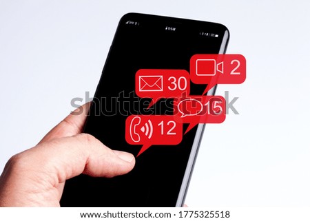 Male hand holding smartphone in isolated white background social networks and flying notification icons
