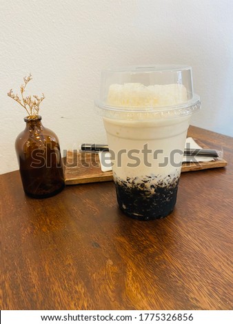 the picture of Soy milk grass Jelly on the wooden table.