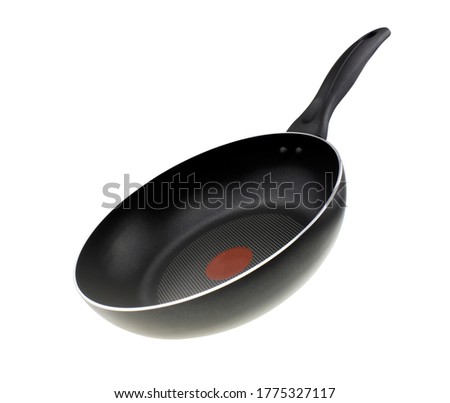 Black teflon skillet with non-stick coated surface isolated on white background