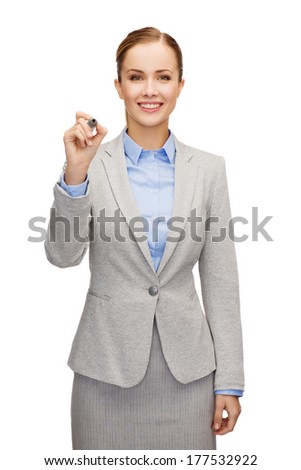 business, office and advertising concept - smiling businesswoman writing something on virtual screen