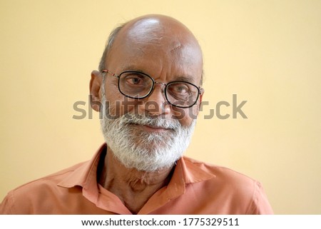   Portrait of smiling senior man with beard.                             
