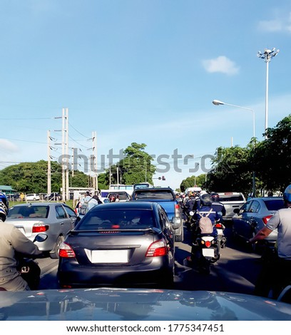 Traffic bottomneck on the road during rush hours in city. People want to go working in the morning in time and go back home quickly in the evening. The heading ways are the same, everyday's traffic