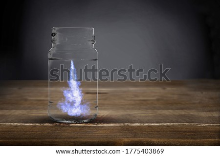 Beautiful blue ink dissolves in water in glass flask