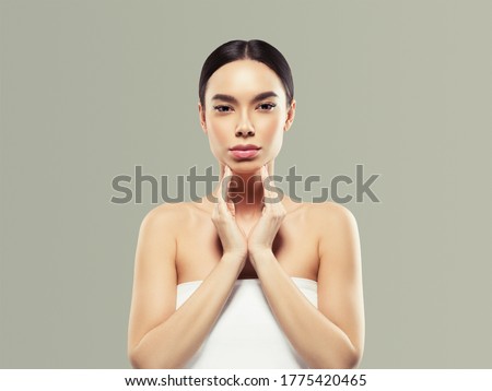Beautiful woman healthy skin care concept portrait with hands close up gray background. Studio shot.