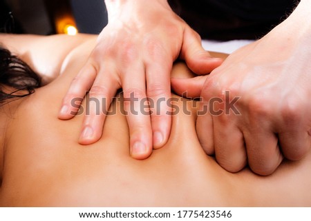 Massage photo. Hands of a massage therapist close-up. Photo of a back massage.