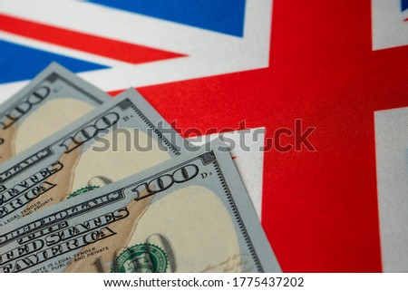 Great Britain national flag and the dollar bills. Business and finance concept, soft focus