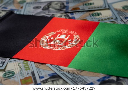 Afghanistan flag with US dollars as background. Concept for investors, soft focus